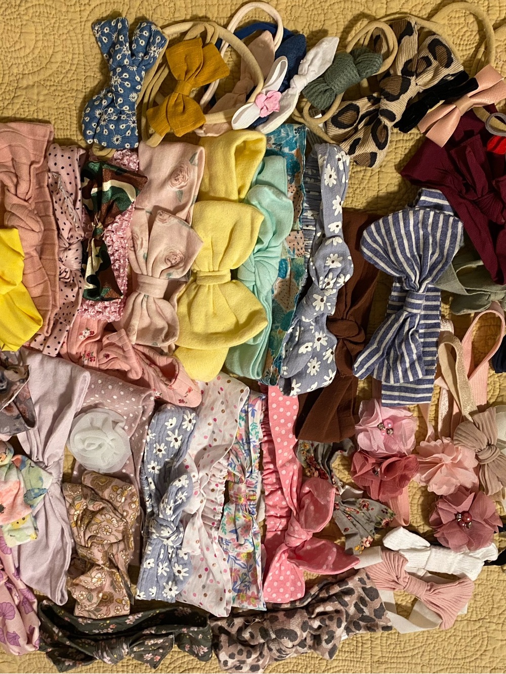 52 Baby bows. Different colors and styles. From flowers to leopard print.